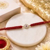 Floral Ruby Stone Rakhi in 925 Sterling Silver with Red Braided Thread