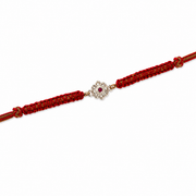 Floral Ruby Stone Rakhi in 925 Sterling Silver with Red Braided Thread
